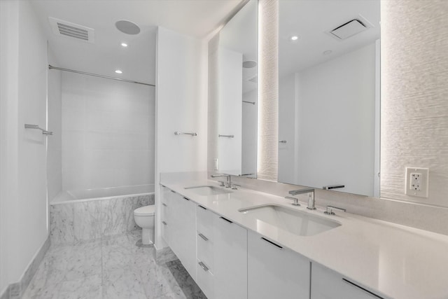 full bathroom with vanity, tile patterned flooring, tiled shower / bath combo, and toilet