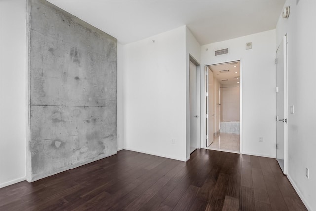 unfurnished room with dark wood-type flooring