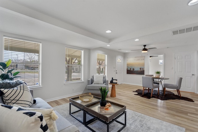 living room featuring ceiling fan and light hardwood / wood-style floors