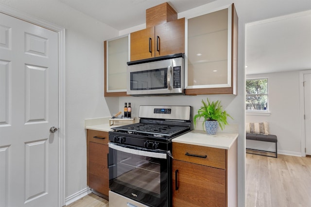 kitchen with stainless steel appliances and light hardwood / wood-style flooring