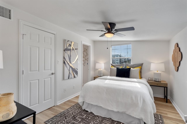 bedroom with ceiling fan and light hardwood / wood-style floors