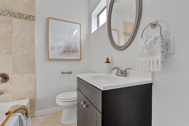 bathroom featuring toilet, vanity, tile patterned flooring, and a bathing tub