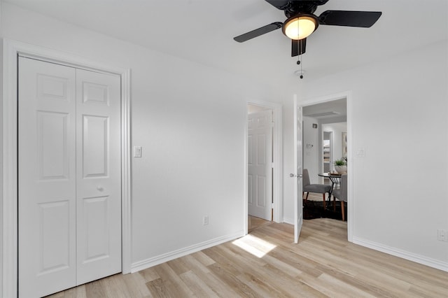 unfurnished bedroom with a closet, ceiling fan, and light hardwood / wood-style flooring