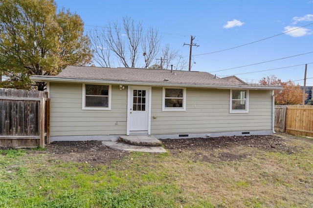 back of property featuring a lawn