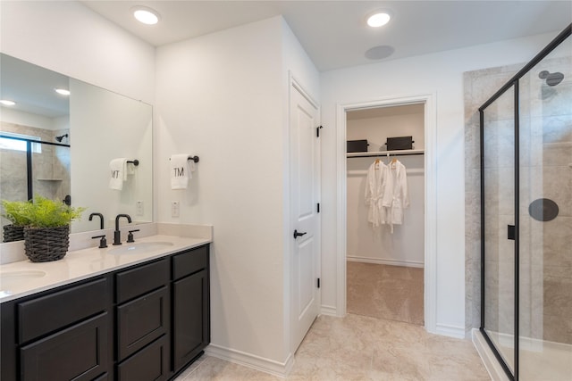 bathroom featuring an enclosed shower and vanity