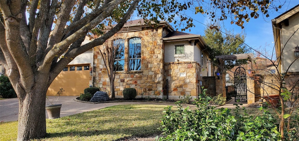 view of front of house with a front yard and a garage