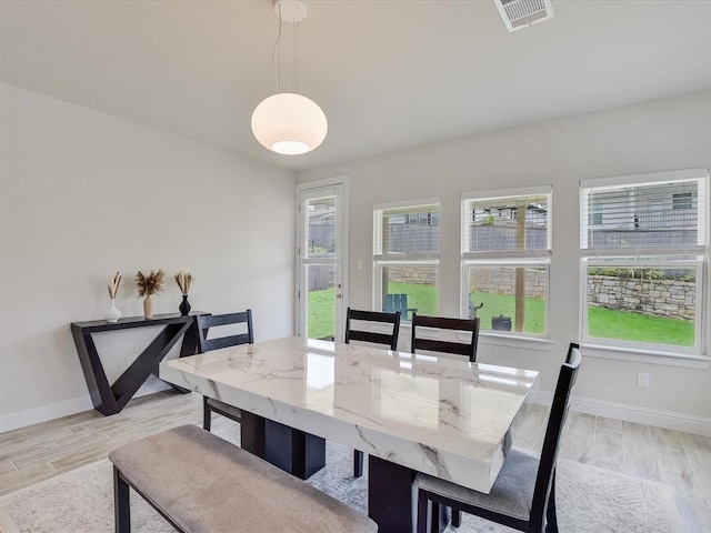 dining space featuring light wood-type flooring