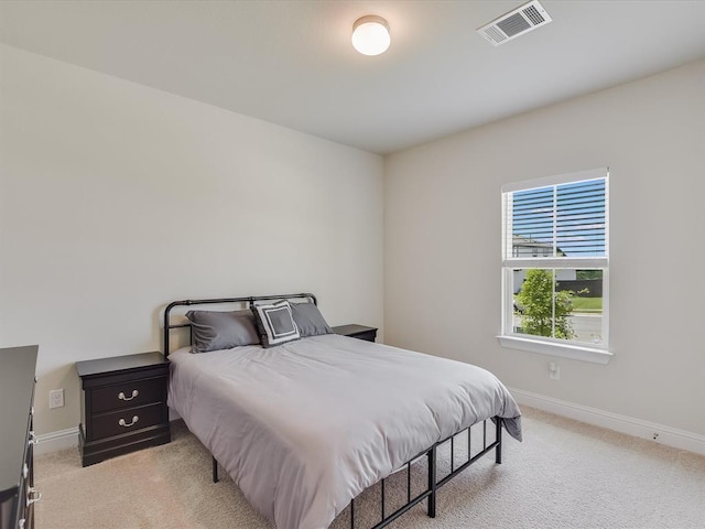 bedroom featuring light colored carpet