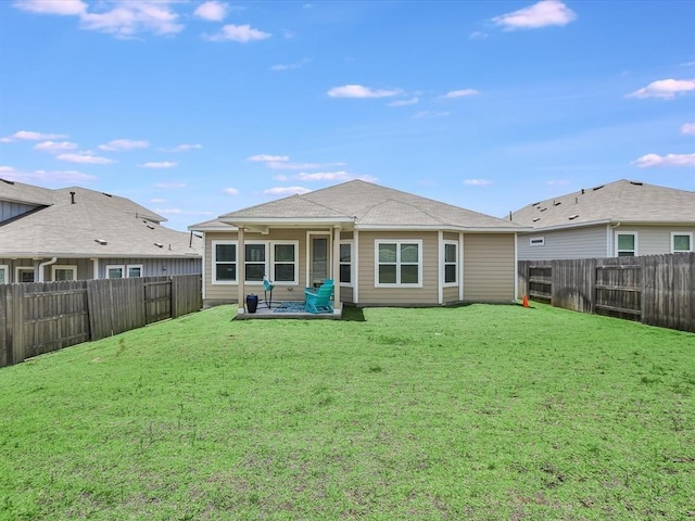 rear view of property featuring a patio area and a lawn