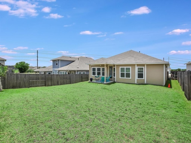 back of house with a lawn and a patio