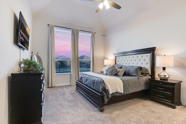 carpeted bedroom featuring ceiling fan and vaulted ceiling