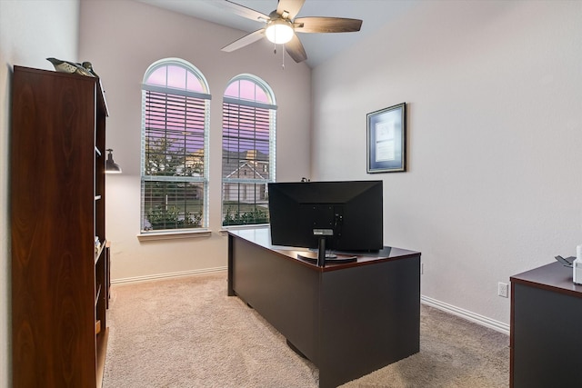 carpeted home office featuring ceiling fan