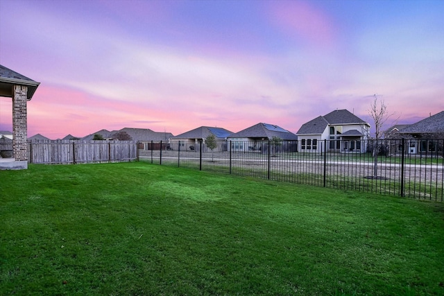 view of yard at dusk