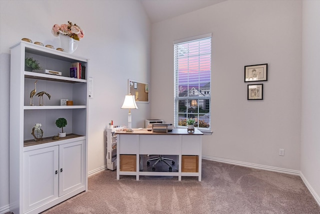 home office with built in features and carpet floors