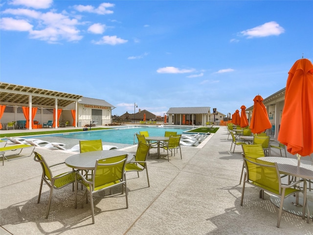 view of swimming pool with a pergola and a patio