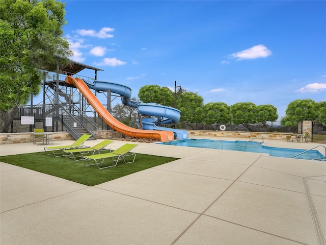 view of jungle gym featuring a patio area and a community pool