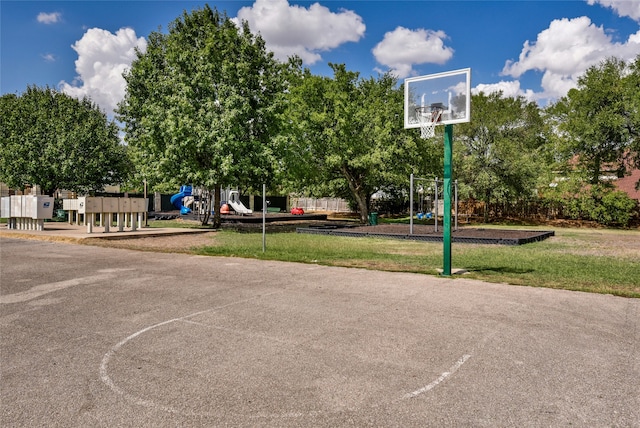 view of basketball court featuring a yard and a playground