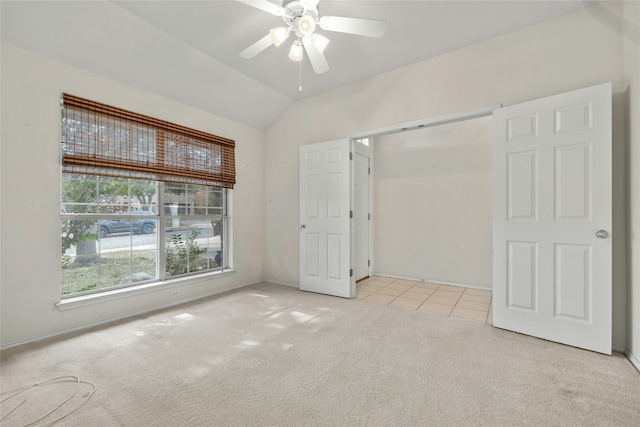 unfurnished bedroom featuring ceiling fan, light carpet, and lofted ceiling