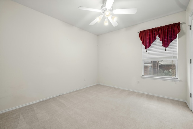 unfurnished room with ceiling fan and light carpet