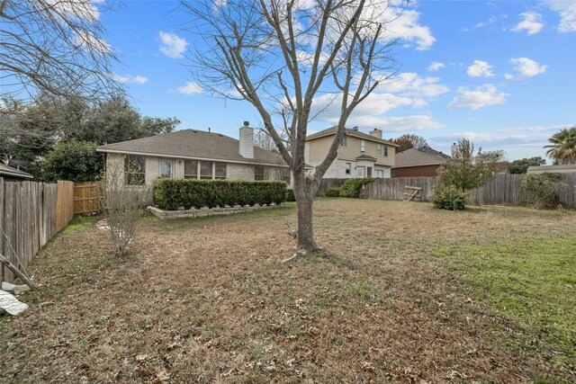 rear view of house featuring a yard