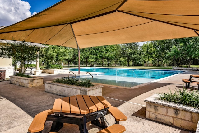 view of swimming pool with a patio area