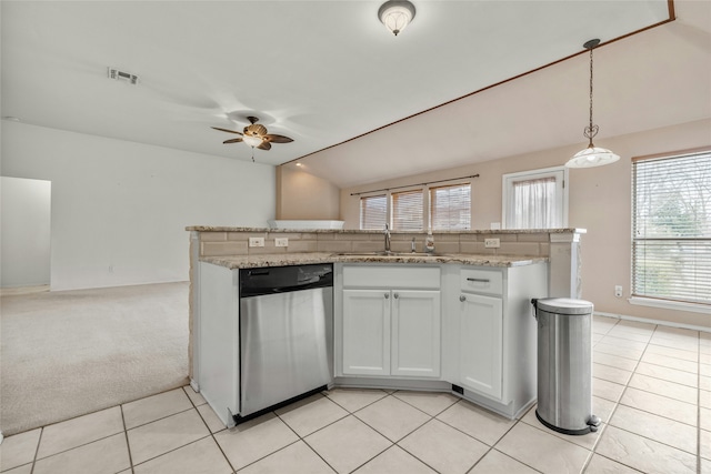 kitchen featuring sink, white cabinets, stainless steel dishwasher, hanging light fixtures, and light colored carpet