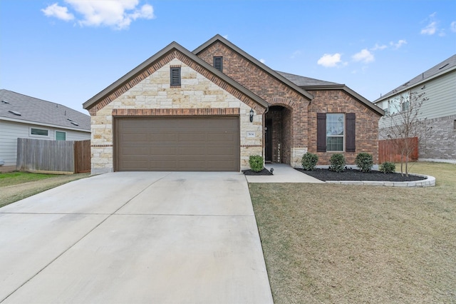 view of front of home with a front yard and a garage