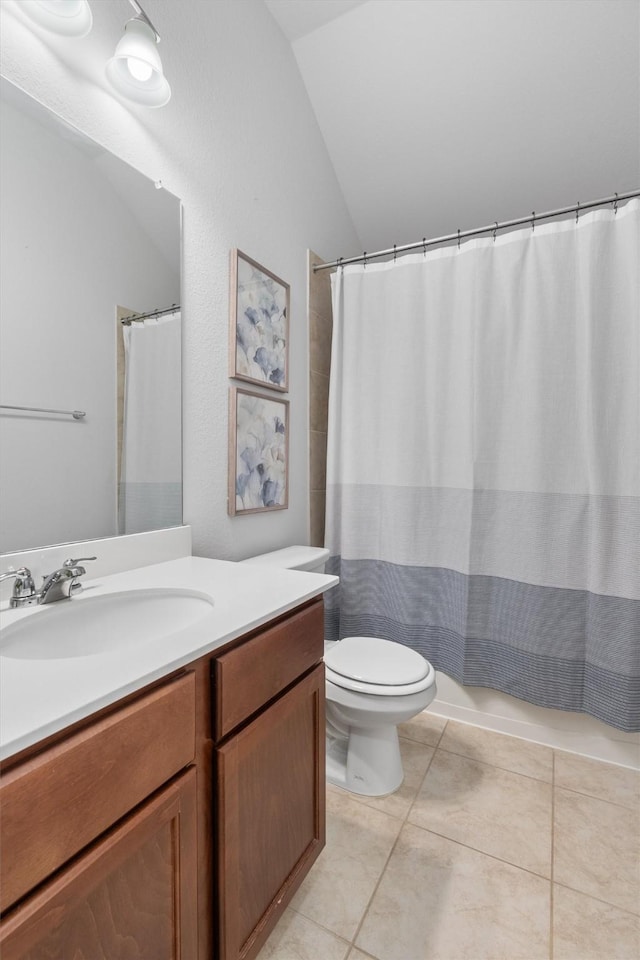 bathroom featuring toilet, lofted ceiling, a shower with curtain, tile patterned floors, and vanity