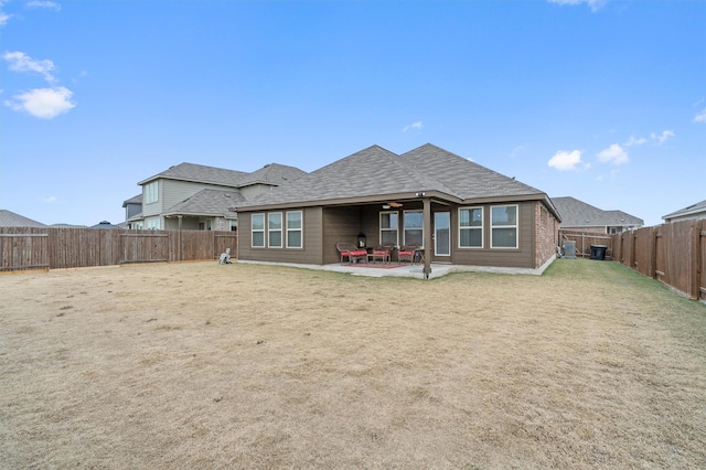 back of house with a yard and a patio