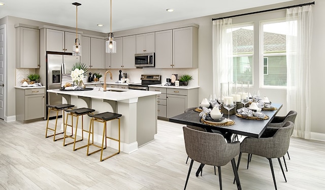 kitchen featuring stainless steel appliances, sink, and gray cabinets