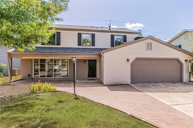 view of front facade featuring a front yard and a garage