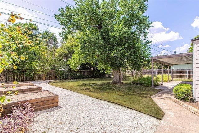 view of yard with a garden and a fenced backyard