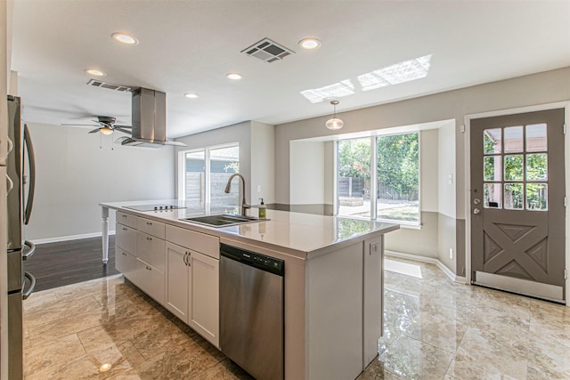 kitchen featuring pendant lighting, stainless steel appliances, an island with sink, white cabinets, and sink