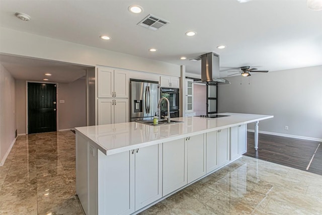 kitchen with island range hood, visible vents, white cabinets, black appliances, and a large island with sink