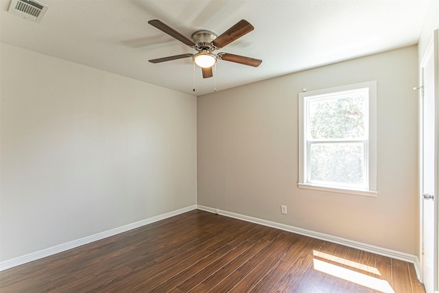 unfurnished room featuring baseboards, visible vents, ceiling fan, and dark wood-type flooring