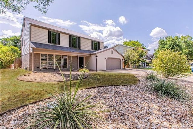 view of front of house featuring a garage, brick siding, concrete driveway, fence, and a front yard