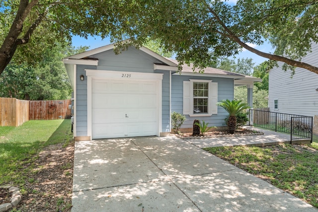 ranch-style home with a front yard and a garage