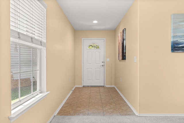 entryway with light colored carpet