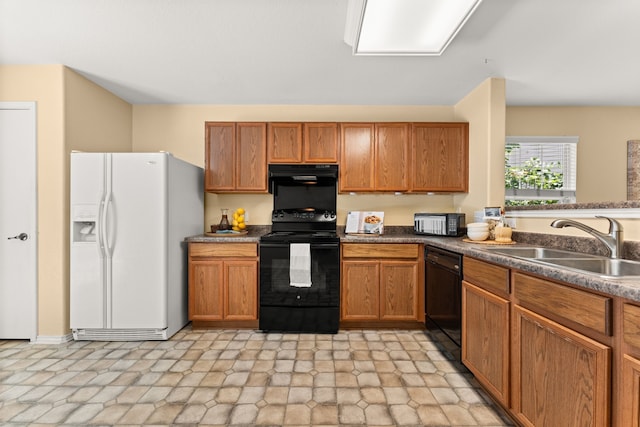 kitchen with extractor fan, black appliances, and sink