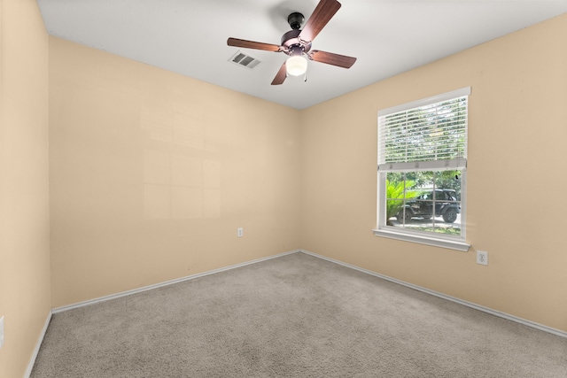 carpeted empty room featuring ceiling fan