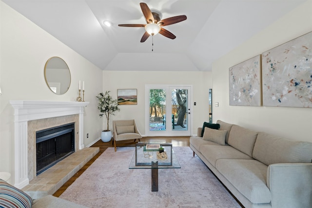 living room featuring ceiling fan, vaulted ceiling, and light hardwood / wood-style floors