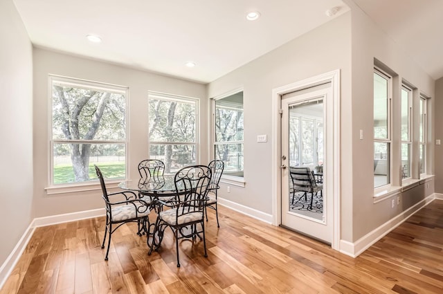 dining room with a healthy amount of sunlight and light hardwood / wood-style floors