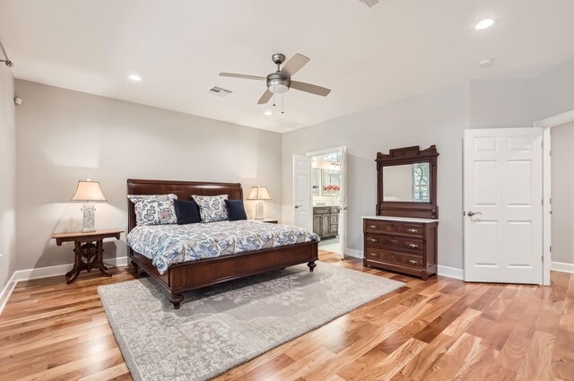 bedroom with ceiling fan, ensuite bath, and light hardwood / wood-style floors