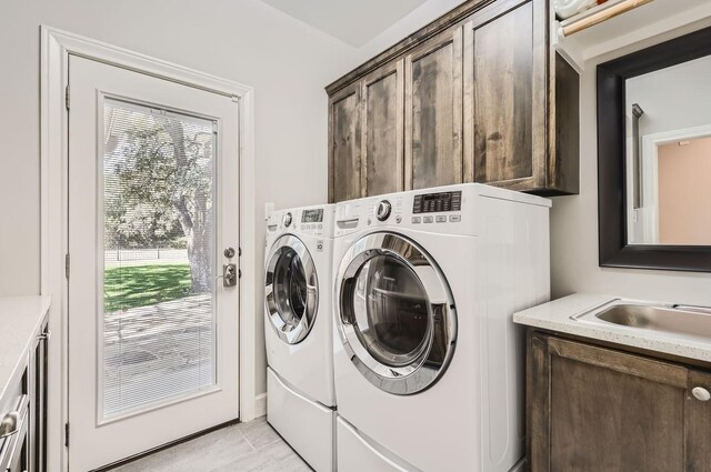 laundry room with cabinets, sink, independent washer and dryer, and light tile patterned flooring