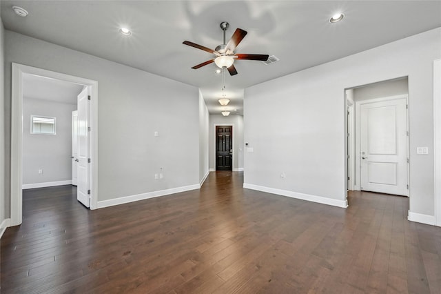 spare room featuring ceiling fan and dark hardwood / wood-style floors