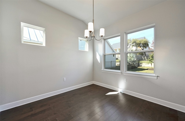 unfurnished dining area featuring lofted ceiling, dark hardwood / wood-style flooring, and a chandelier