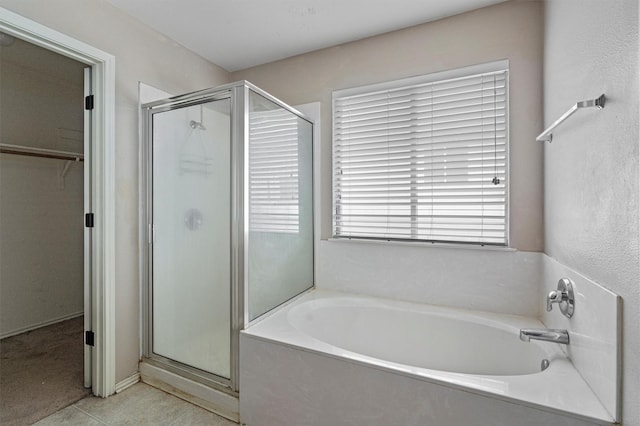 bathroom featuring tile patterned flooring and plus walk in shower