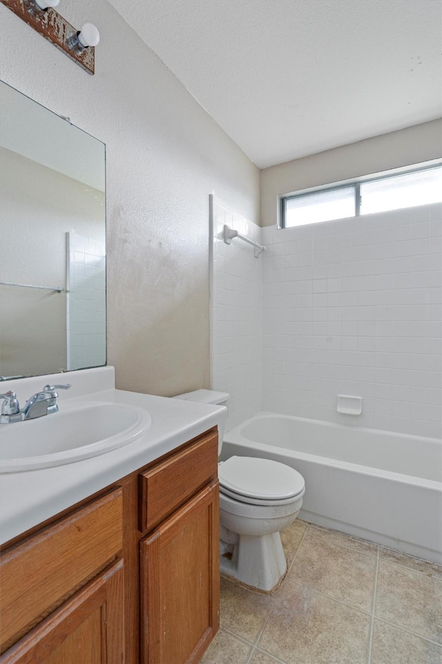 full bathroom featuring washtub / shower combination, vanity, and toilet