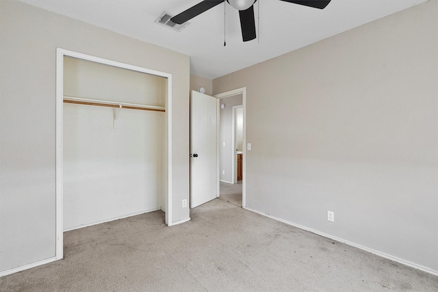 unfurnished bedroom with light colored carpet, ceiling fan, and a closet