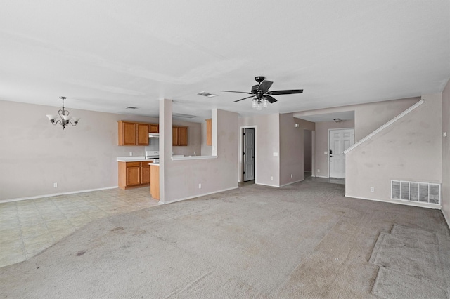 unfurnished living room with light colored carpet and ceiling fan with notable chandelier